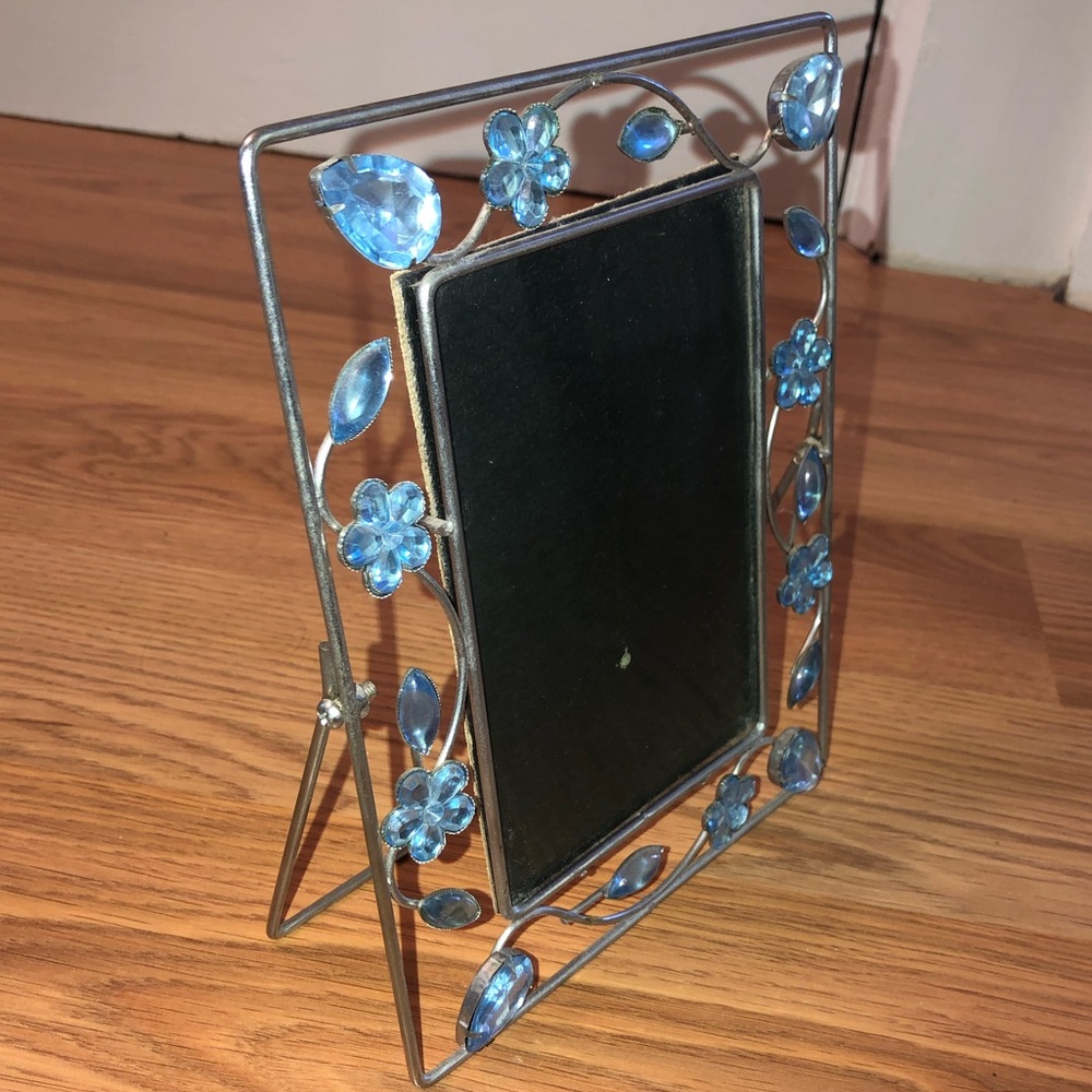 Blue flower/pedal silver picture frame. Cardboard back to hold picture.